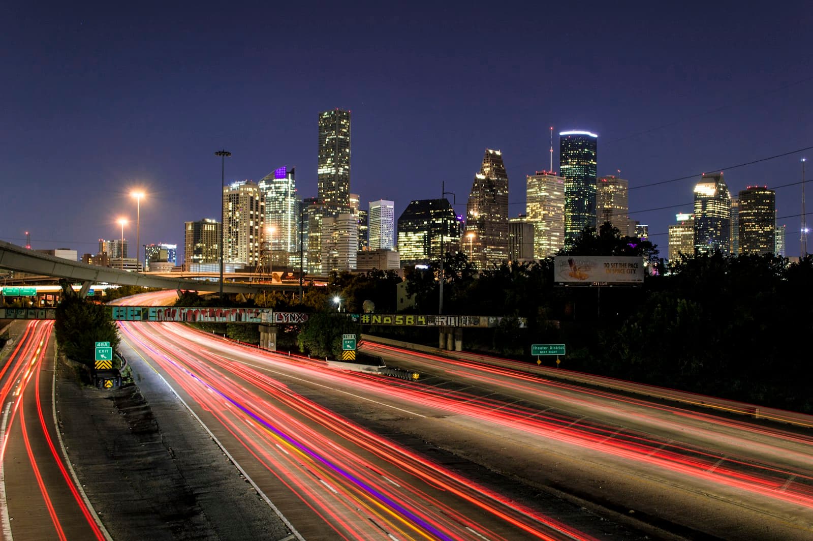 The Houston skyline at night seen from the freeway